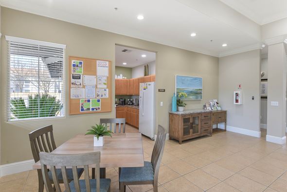 North Highlands apartment for rent - Community kitchen and dining space with bulletin board at Corsair Park Senior Apartments, California