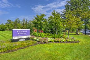 Ashburn apartment for rent - Property entrance sign with colorful flower landscaping at Acclaim at Ashburn Apartments, Virginia, 20147