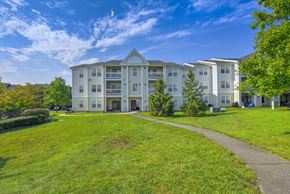 Ashburn apartment for rent - Apartment buildings with green lawn at Acclaim at Ashburn Apartments, Ashburn, Virginia