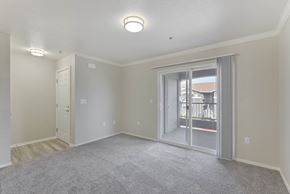 North Highlands apartment for rent - Empty apartment living room with balcony access at Corsair Park Senior Apartments, California