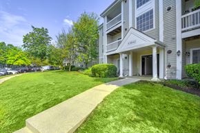 Ashburn apartment for rent - Apartment building exterior with landscaped walkway at Acclaim at Ashburn Apartments, Virginia, 20147
