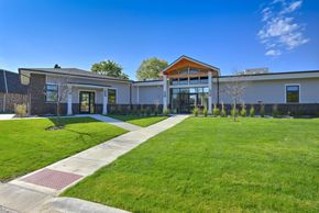 Willowbrook apartment for rent - Modern clubhouse exterior with landscaped lawn at Photo Gallery Apartments, Illinois, 60527