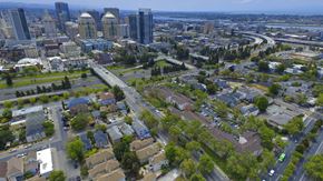 Oakland apartment for rent - A cityscape with a mix of residential and commercial buildings at Oak Village Apartments, Oakland, CA