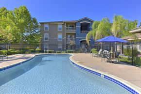 Rocklin apartment for rent - Swimming pool with patio furniture and iron safety fence at Whitney Ranch Apartments, Rocklin, 95765