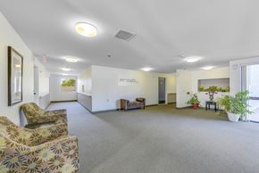 Pasadena apartment for rent - A spacious waiting room with a sofa, chairs, and potted plants.