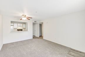Roseville apartment for rent - Living room with kitchen pass through and ceiling fan at Woodcreek Terrace Apartments, Roseville, 95747