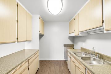 Long Beach apartment for rent - A kitchen with wooden cabinets and a sink.