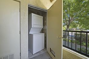 Sacramento apartment for rent - A white refrigerator and freezer are installed in a small outdoor space at Hurley Creek Apartment Homes, Sacramento, California