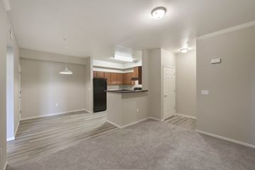 Elk Grove apartment for rent - A spacious living room with a kitchenette in the background.