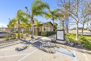 Yorba Linda apartment for rent - A parking lot with a sign and a building in the background at Yorba Linda Apartments, Yorba Linda, CA 92886