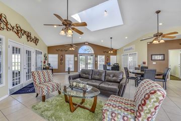 Orlando apartment for rent - A living room with a glass table and a sofa.
