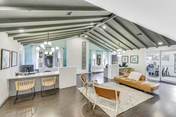 Austin apartment for rent - A living room with a white couch and wooden chairs.