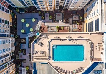Orlando apartment for rent - An aerial view of a pool surrounded by buildings.