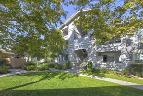 Dixon apartment for rent - A white building with a green lawn in front.at Lincoln Creek Apartments, Dixon, CA