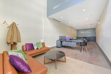 Chicago apartment for rent - A living room with a brown couch and a glass coffee table.