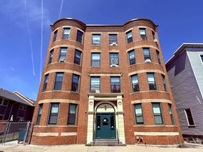 Roxbury apartment for rent - A red brick building with a green door in front.