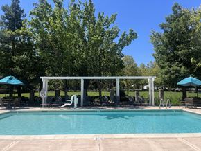 Elk Grove apartment for rent - Swimming pool with pergola and lounge seating at Renwick Square Apartments, California, 95758
