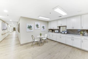 Largo apartment for rent - A kitchen with white cabinets and a dining table with chairs.