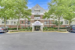 Largo apartment for rent - Parking lot in front of the building at Vistas at Lake Largo 55+ Senior Community, Largo, 20774