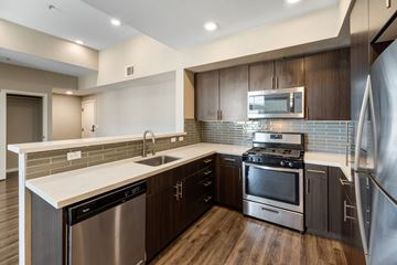 American Canyon apartment for rent - A modern kitchen with dark wood cabinets and stainless steel appliances.