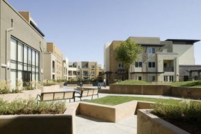 New York apartment for rent - A modern building complex with a courtyard in the foreground.