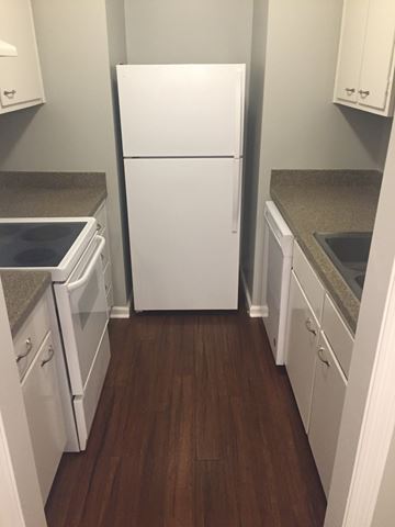 Indianapolis apartment for rent - A white refrigerator in a kitchen with white cabinets and a white dishwasher.