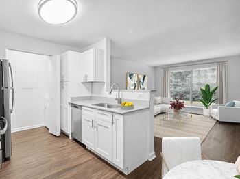 A kitchen and living room with a large window