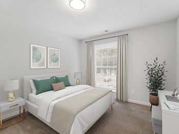 A bedroom with a white bed and green pillows