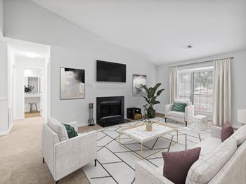 A living room with a fireplace and a tv above it