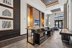 Cincinnati apartment for rent - A modern dining area with a long table and chairs.