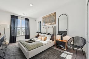 Windsor apartment for rent - A bedroom with a large bed and a chair.