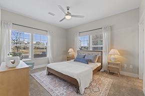 Foley apartment for rent - A bedroom with a bed, nightstands, and a ceiling fan.
