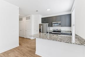 Indianapolis apartment for rent - Open kitchen layout with dark cabinets and island at Nook Nine Apartments