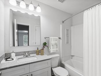 A bathroom with a sink toilet and bathtub