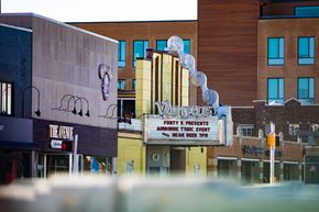 Indianapolis apartment for rent - A blurry image of a street with a cinema advertising an event.