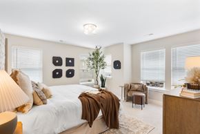 Brownsburg apartment for rent - A bedroom with a large bed and a chair.