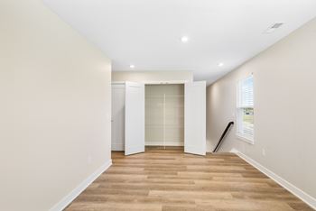 A room with a wooden floor and white walls.