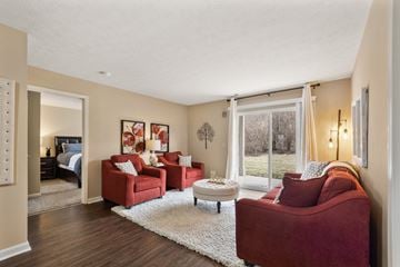 Terre Haute apartment for rent - A living room with red couches and a white rug.