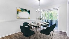 Marietta townhouse for rent - a dining room with a table and chairs at Elea Apartments in Marietta, GA
