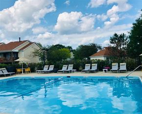 Schaumburg apartment for rent - Lounge chairs by pool at The Winds at Poplar Creek, Schaumburg, Illinois