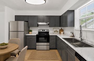 Nashville apartment for rent - A modern kitchen with a refrigerator, oven, and sink.