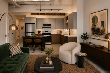 Indianapolis apartment for rent - A modern kitchen with a green couch and a coffee table in the foreground.