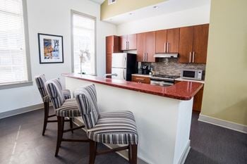 Fitted kitchen with island dining