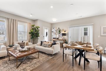 Lewis Center apartment for rent - A well-lit living room with a brown leather coffee table and white sofas.