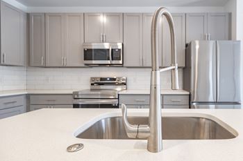 A modern kitchen with stainless steel appliances and white cabinets