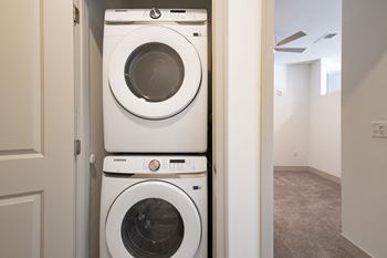 A front loading washer and dryer in a laundry room