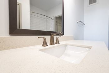 A bathroom with a sink and a mirror