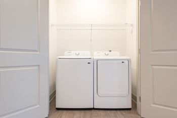 A washer and dryer in a laundry room with white walls