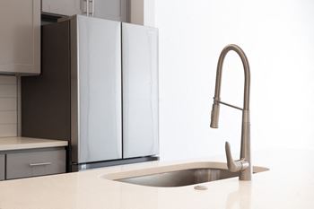 A kitchen with a sink and a faucet