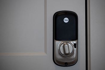An image of a door handle with a cell phone on it